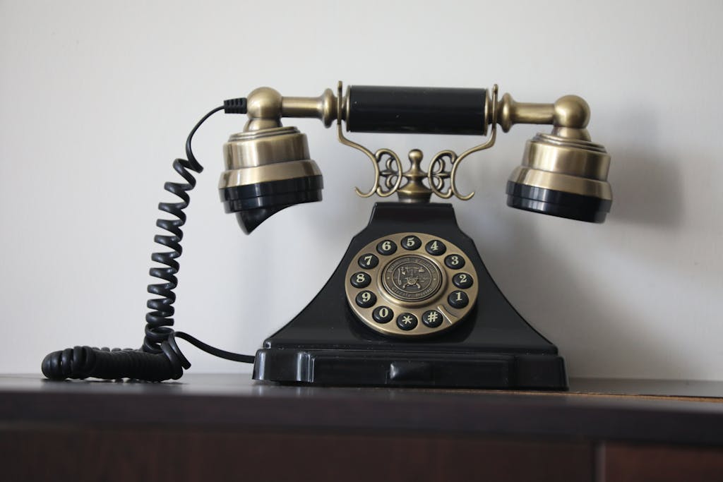Classic black and brass rotary dial telephone featuring antique design, evoking nostalgia.